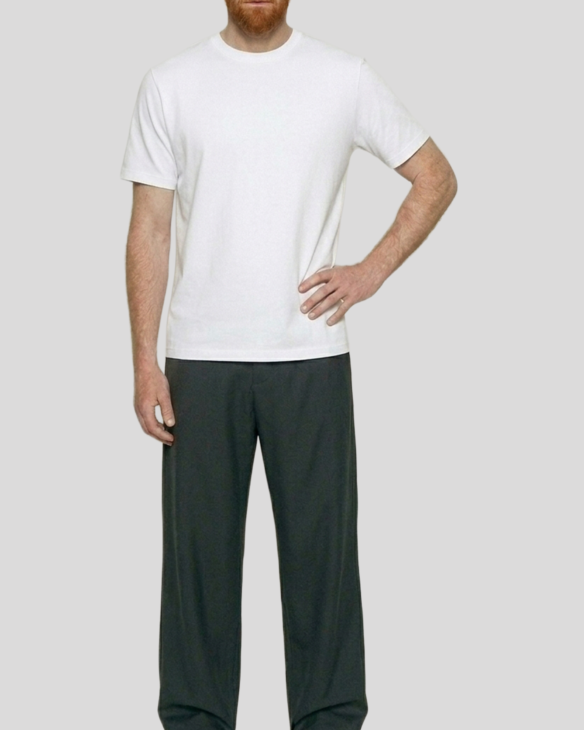 Person wearing a white t-shirt and dark pants on a plain background